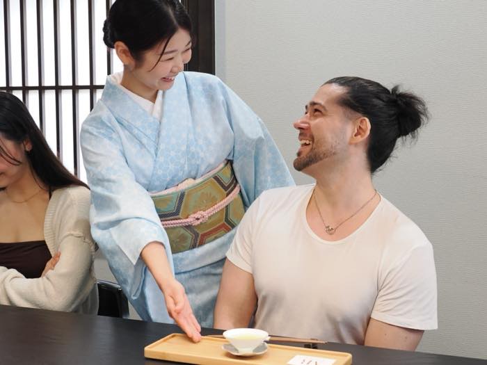 A guest whisking a bowl of matcha at OCHARU